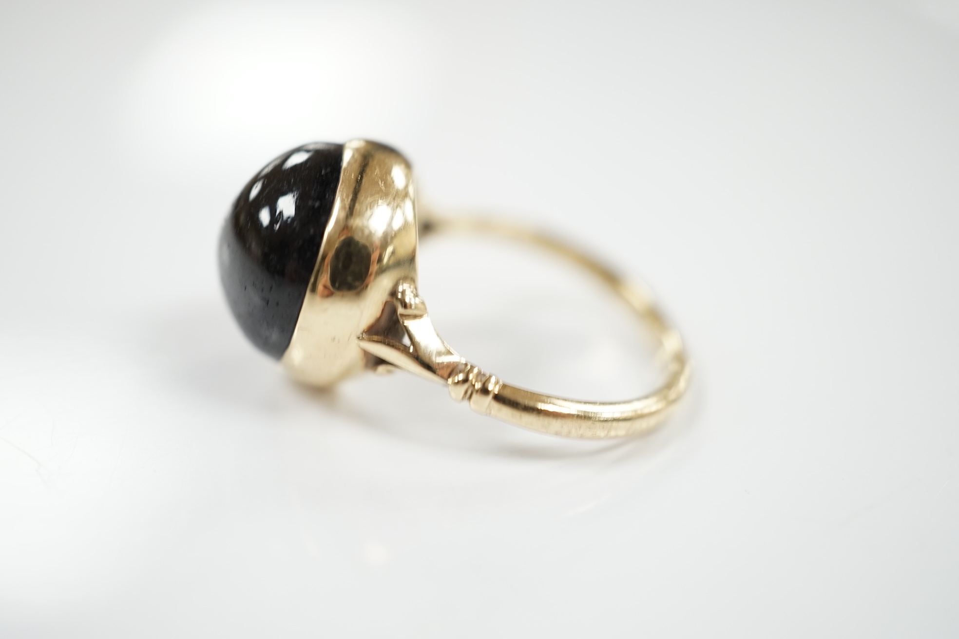 A modern 9ct gold and single stone cabochon black star sapphire set ring, size O/P, gross weight 6.3 grams. Condition - poor to fair